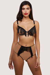 Model wears retro nude mesh and black fringe lingerie set