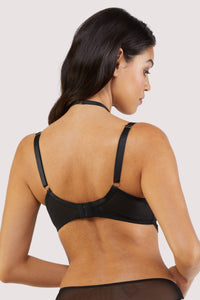 Back view of a black lacy fishnet plunge bra with gold hardware.