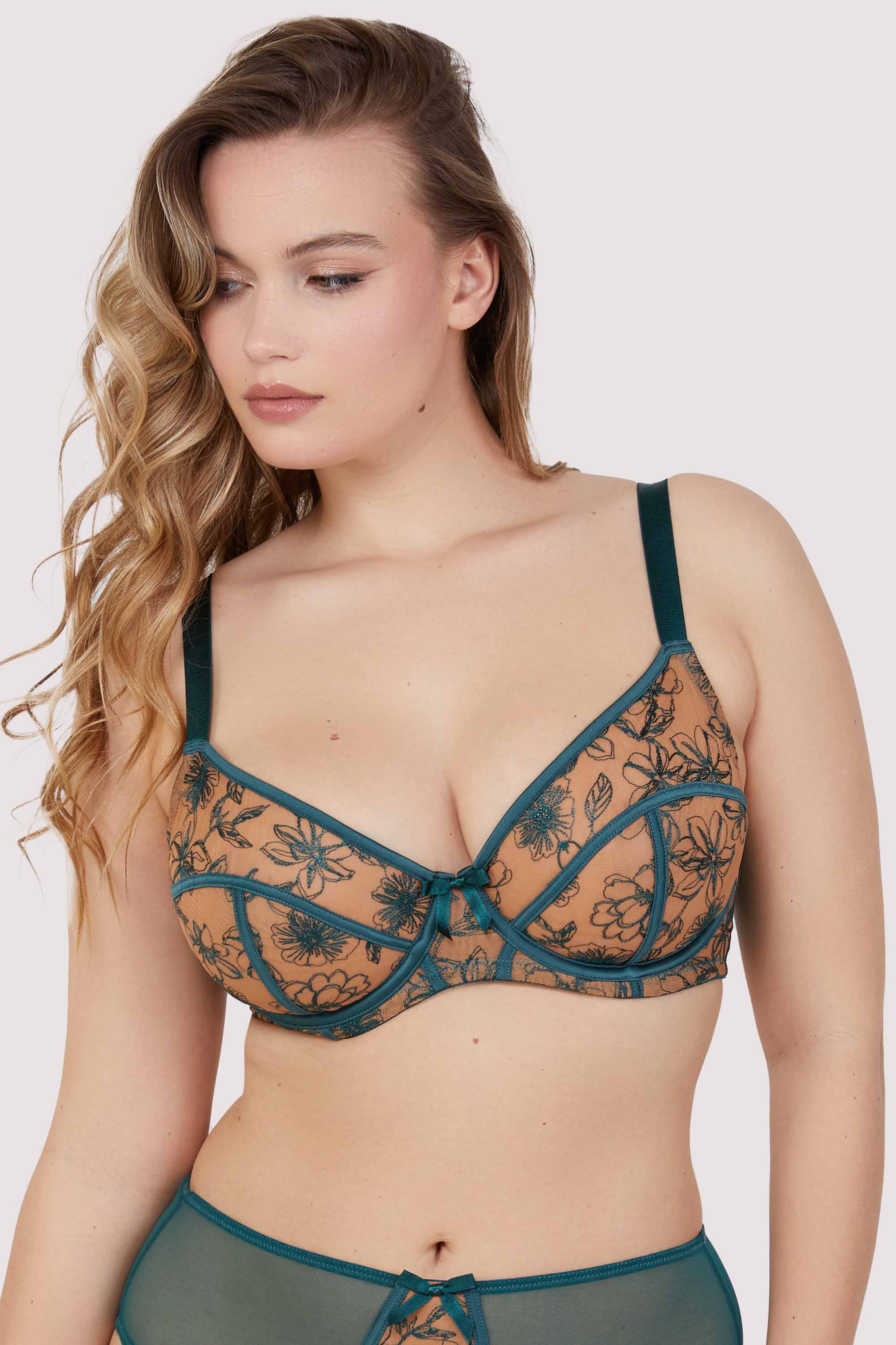 Model wears a teal contrast embroidery balconette bra with underwire plunge cups, nude mesh, and teal floral embroidery, featuring thick adjustable straps and satin seam detailing