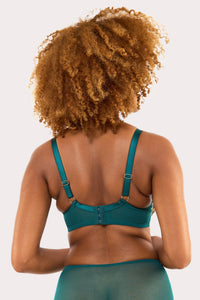 Model shows back of teal contrast embroidery balconette bra featuring thick adjustable straps and hook and eye fastening on supportive back band