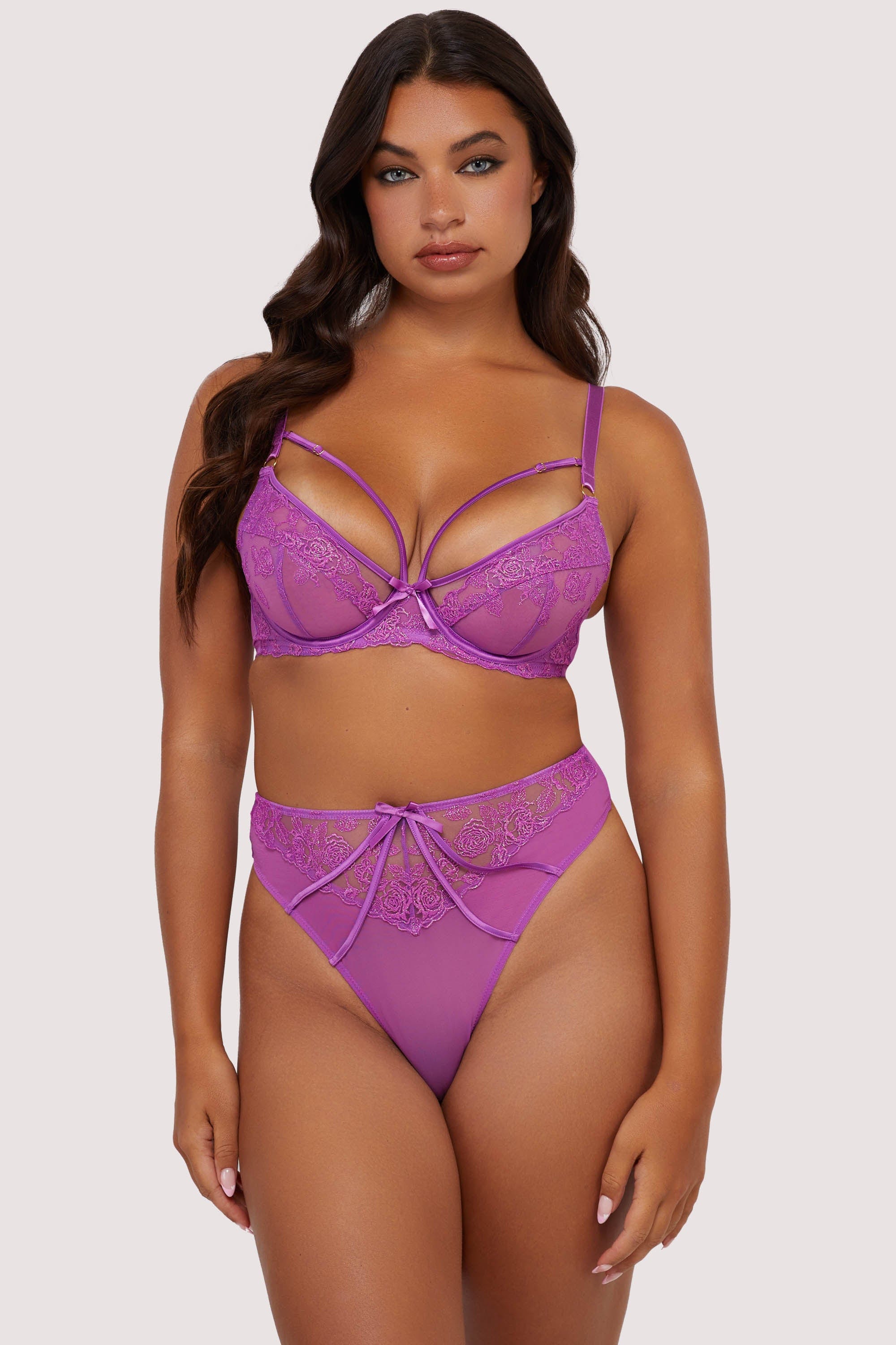 Model wears purple strappy lace plunge bra and high waist thong lingerie set