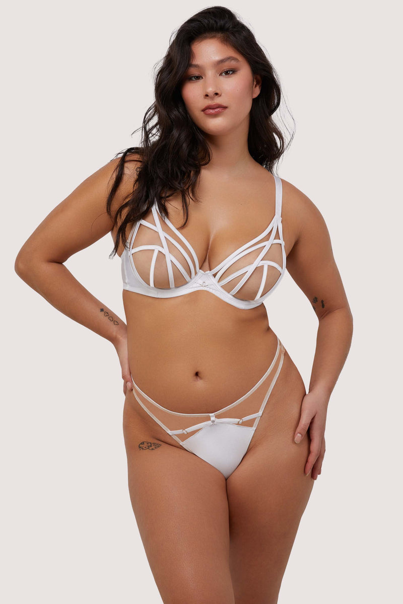 Model wears sexy white strap detail lingerie set