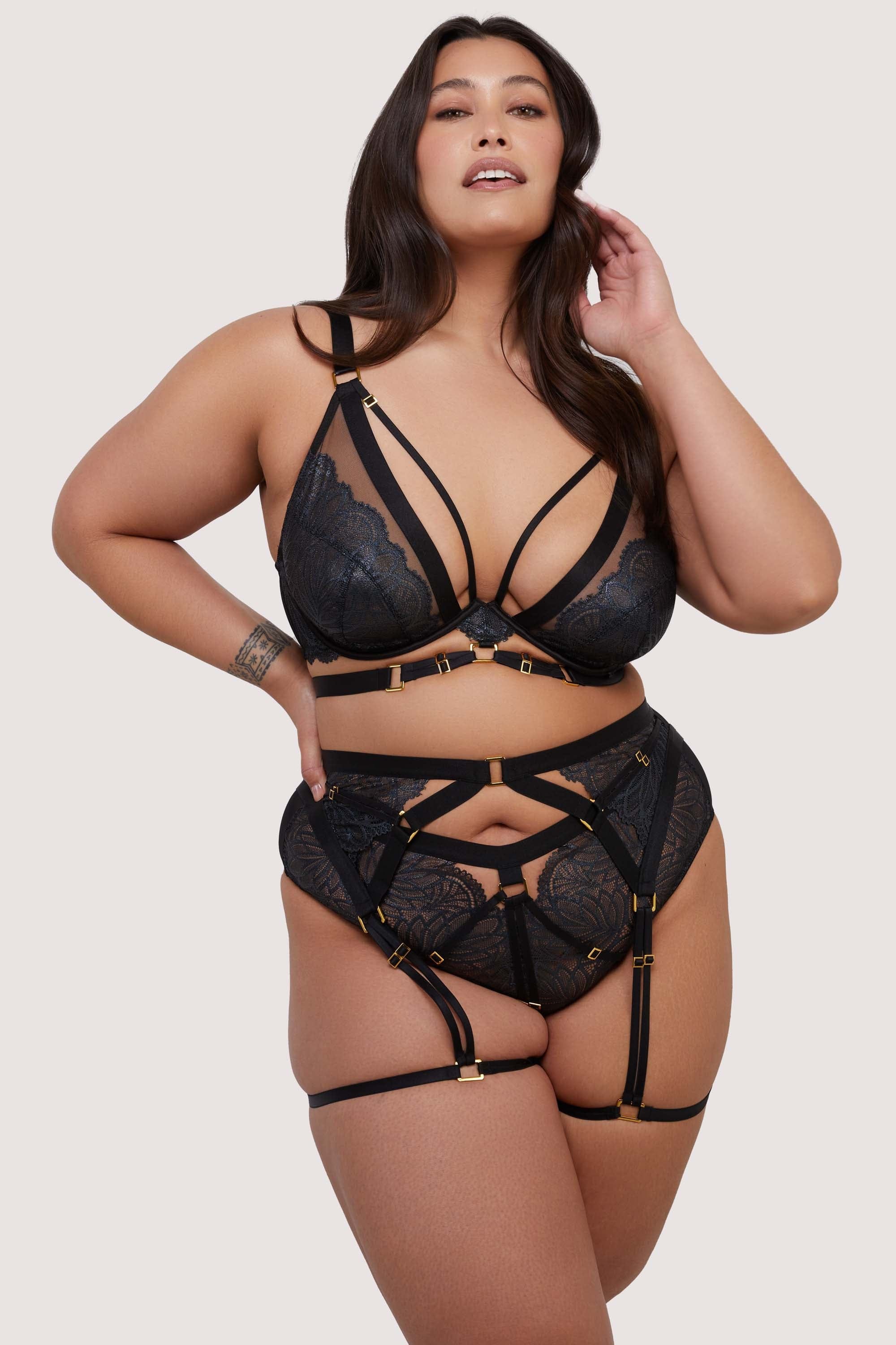 model wears black lace lingerie set with thigh harness suspender