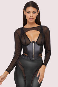 Model wears a black shrug with super cropped long sleeve bolero, with a matching underbust corset and pencil skirt.