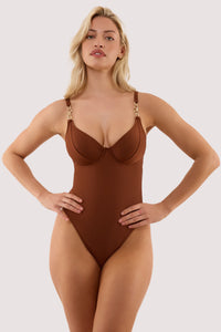Model wears a tamzin chocolate brown underwired swimsuit with hardwear