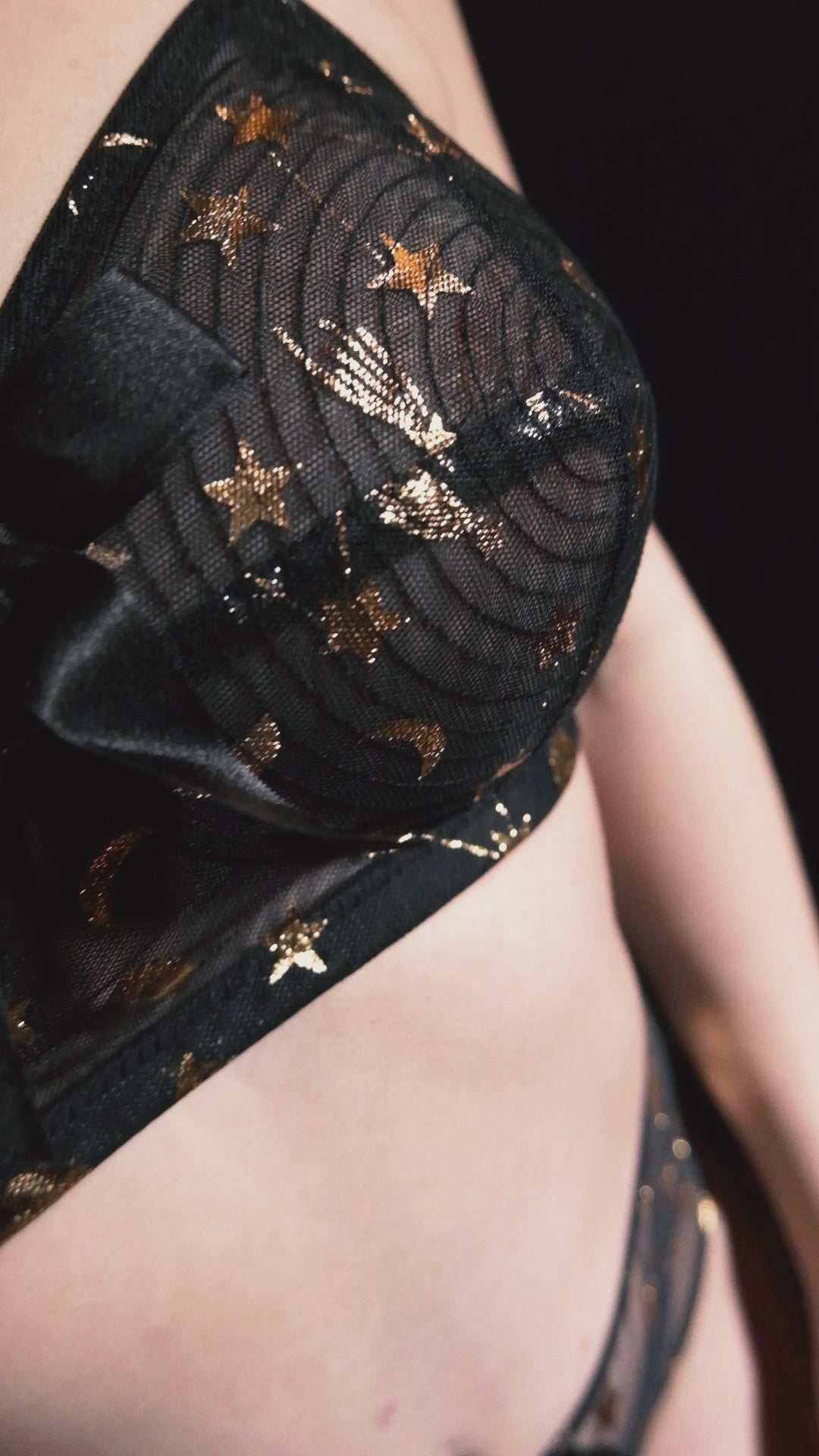 Core|model wears Solar black and gold cosmic print bullet bra with high waist brief and girdle with suspender